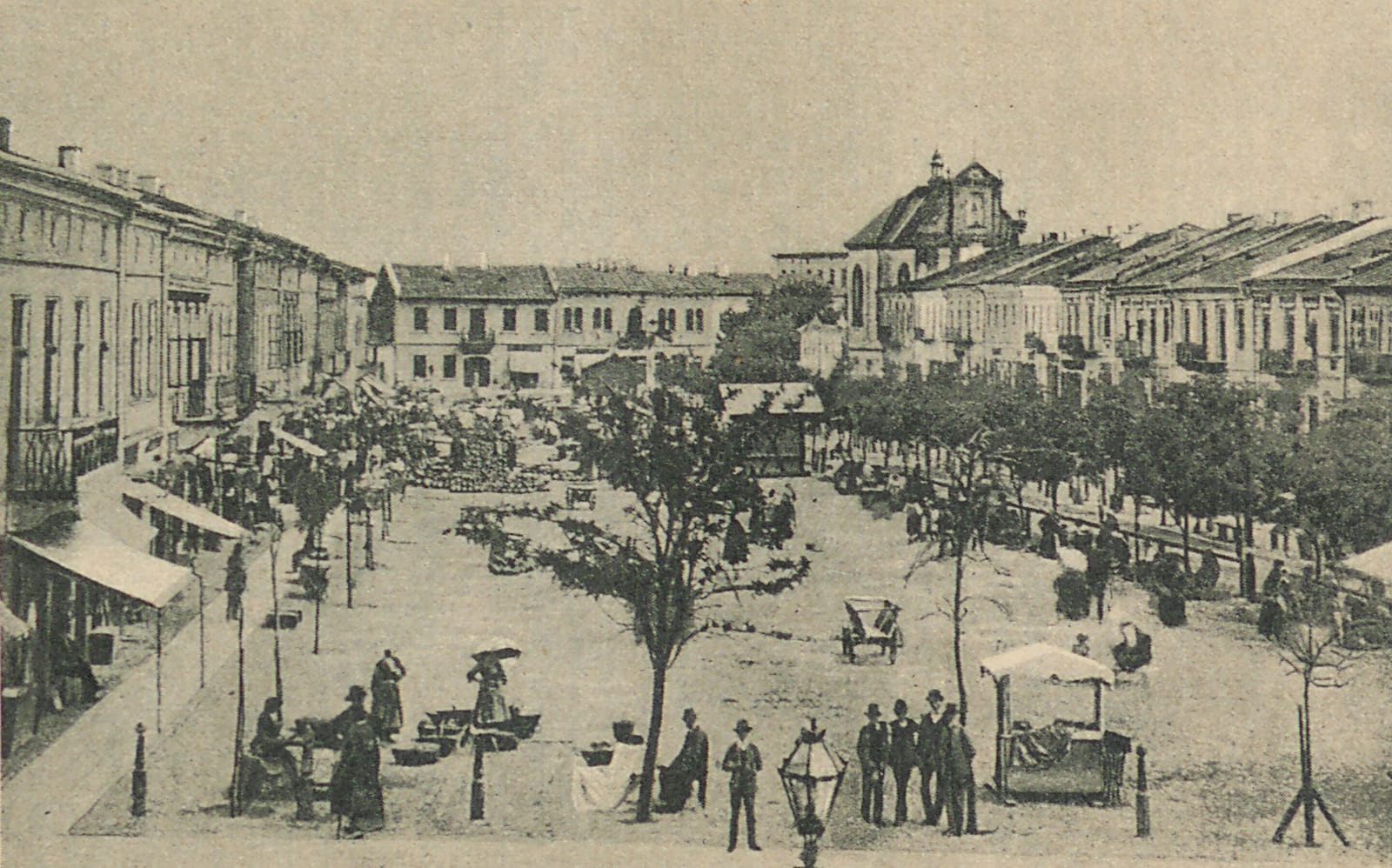 A printed view of the Kolomyia market square about 1892, with stalls, trees, and a church front.
